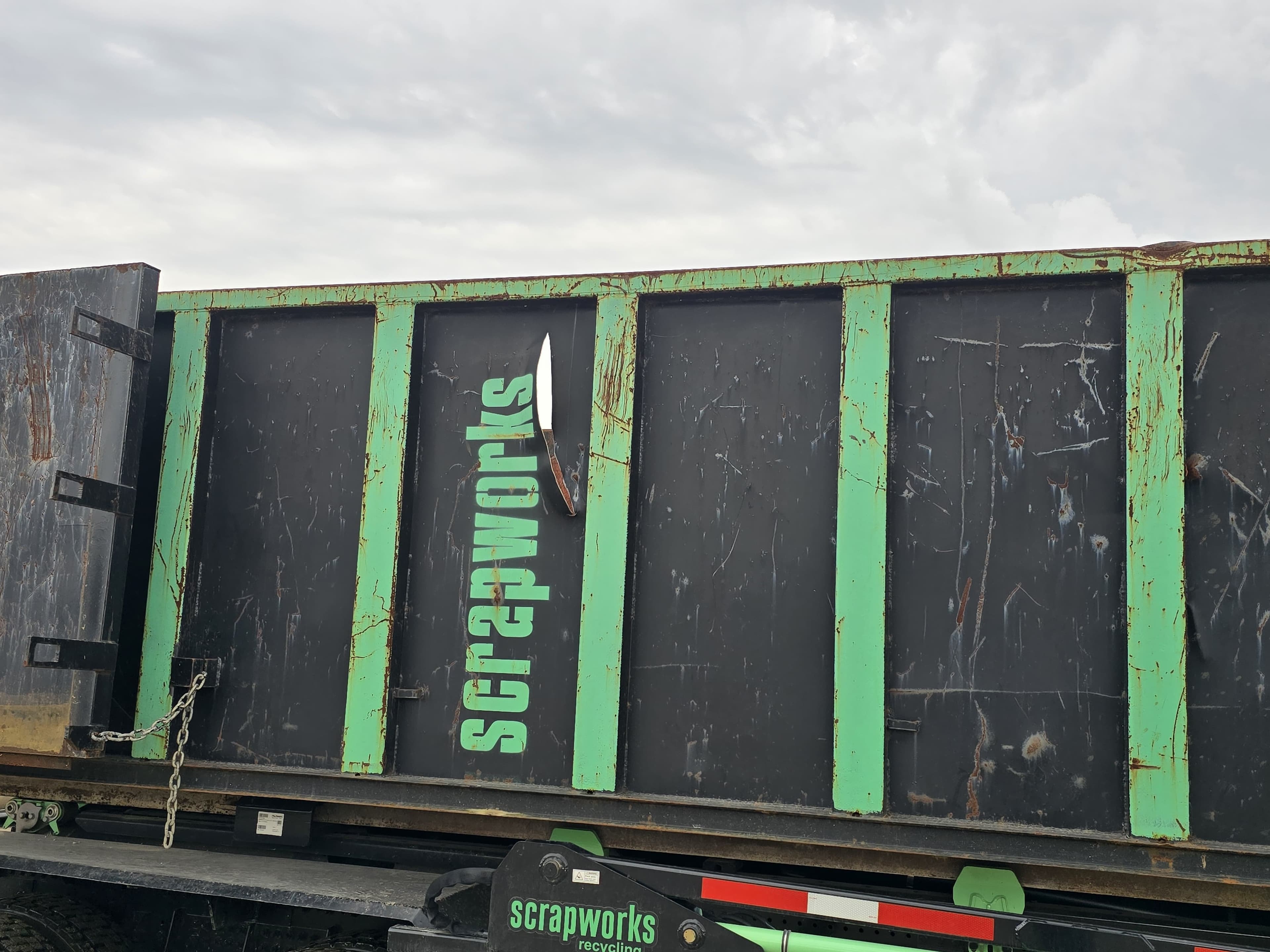 Roll-off container loaded on a Scrapworks Logistics truck